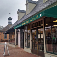 A building exterior with a green awning that says bookstore and cafe 