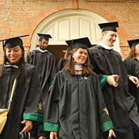 Students from the Class of 2020 pass through the Wren building on their walk across campus.