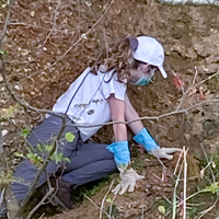 A student inventories fossils on a rock outcrop