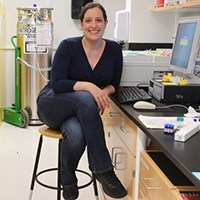 Rachel O’Brien sits at a desk in her chemistry lab
