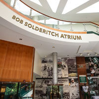 Bob Solderitch Atrium with gold letters above photo montage on wall