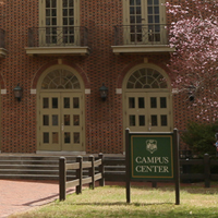The Campus Center sign with part of the building behind it
