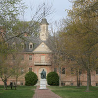 The statue of Lord Botetourt with a portion of the Wren Building in the background on a fall day