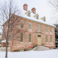 Historic campus building The Brafferton in snow.