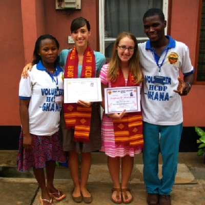 SPIMA Trip Leaders Gloria Driessnack (center left) and 玛丽 Kate Wise (center right) were presented with certificates by members of HCPD-Ghana during their previous service trip to Ghana. Richard Anku, Executive Director of HCPD-Ghana, is on the right.
