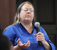 An audience member asks a question during the discussion portion of the event.