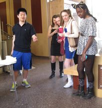 A physics student tosses some liquid nitrogen across the floor of the Small Hall lobby on Newton Day. Photo by Joseph McClain