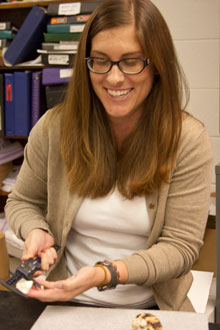 Graduate student Summer Moore uses calipers to measure a shell recovered from a Polynesian midden. Photo by Shelby Roller