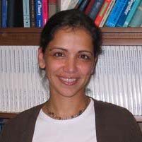 Rani Mullen standing in front of a bookshelf