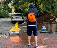 W&M student putting out a fire during safety training