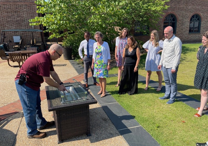 Staff being instructed on how to safely use a fire pit.