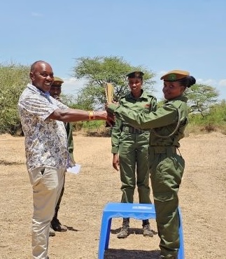 John Kamanga, SORALO Executive Director, awards the "Best-all-around" ranger assessment award to Precious Kotonto. PHOTO: SORALO