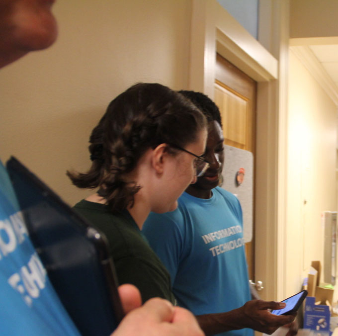 IT worker assists a student in connecting to eduroam