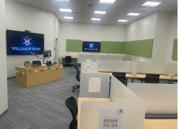 photo of the testing center with student desks and proctor's desk on the side of the room.
