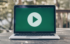 Play icon on an open laptop